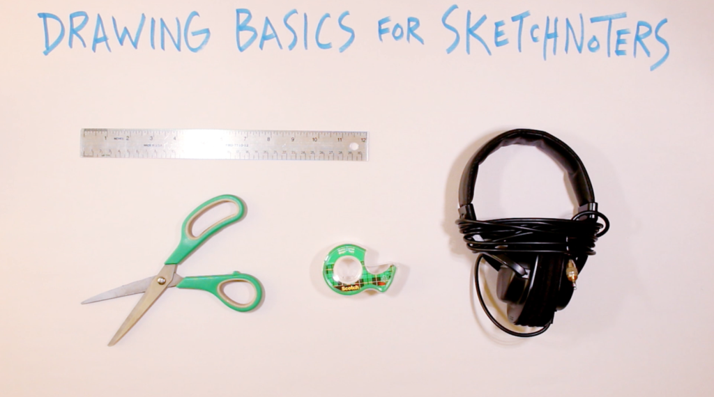 A flat lay photo showing four objects on a white surface beneath the hand-lettered title 'Drawing Basics for Sketchnoters' written in blue marker. The objects are a metal ruler at the top, a pair of green-handled scissors at the bottom left, a roll of Scotch tape in the center, and a pair of black over-ear headphones with the cord wrapped around them on the right.