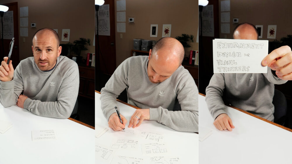 A three-panel image of Doug Neill in a gray sweatshirt at a white desk. In the left panel, he holds up a pen and looks at the camera. In the middle panel, he leans over the desk sketching on paper surrounded by hand-drawn visual notes. In the right panel, he holds up a small card with the hand-lettered words "Environment Design for Visual Thinkers.
